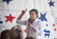 Unknown woman speaking and gesturing at a political event.