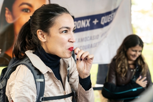 Woman eating candy at outdoor event.