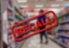 "Recall" sign on blurred supermarket background.