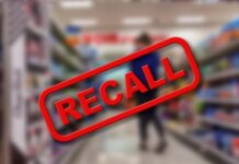 "Recall" sign on blurred supermarket background.