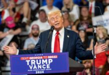 donald trump speaking at rally with Trump Vance sign