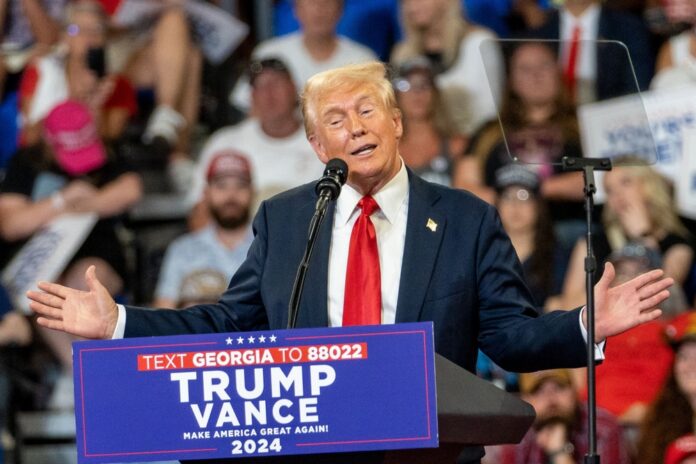 donald trump speaking at rally with Trump Vance sign