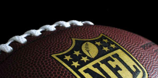 Close-up of football with NFL logo.
