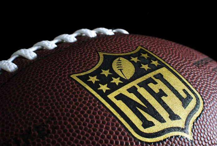 171914738 Close-up of football with NFL logo.
