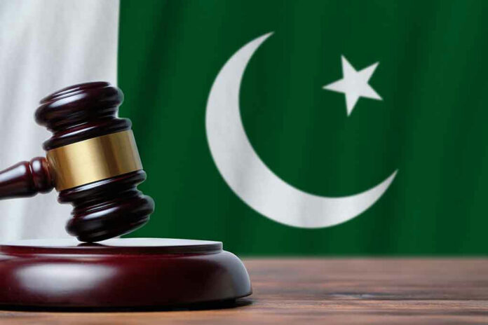 1790503265 Gavel with Pakistan flag in the background.