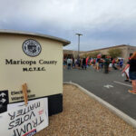 Judge CRUSHES Ballot Rebrand—41,000 Signatures Erased… Protest outside Maricopa County elections building with signs.