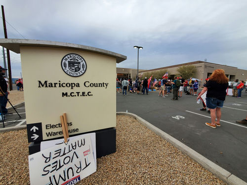 shutterstock1849377868-1jpg Protest outside Maricopa County elections building with signs.