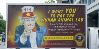 A van with an anti-NIH billboard featuring Anthony Fauci.