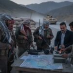 Iran Militia Kidnaps American — Forces Trump’s Hand… Military personnel and officials discussing a map at a checkpoint