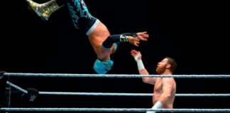 Two wrestlers mid-match, one performing an aerial move.