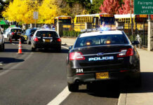 School Buses Turned Big Brother Spy Machines? Police cars and school buses on a sunny street.