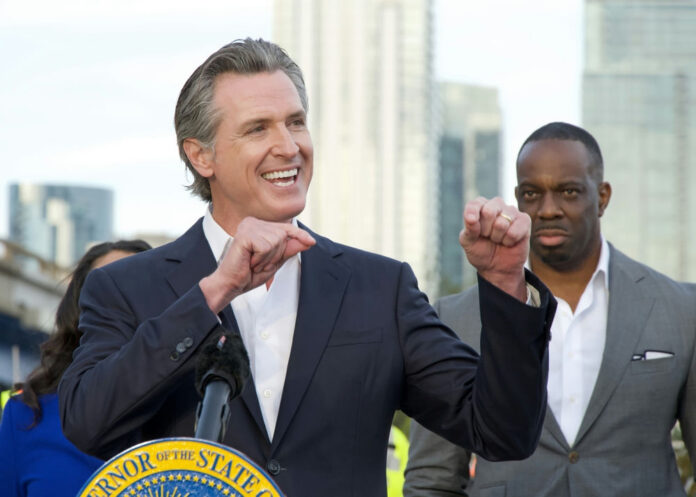 2387585363-1 Smiling man giving a speech at an outdoor event.
