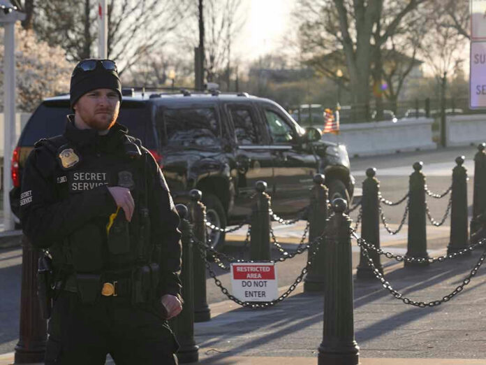 Secret Service agent standing near restricted area sign.