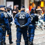 Police Scandal ERUPTS: Officers Accused in SPAIN Police officers in uniform gather on a city street