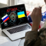 Online Jihad Guidance UNCHECKED: What’s Happening? Laptop displaying ATTACK with Russian and Ukrainian flags