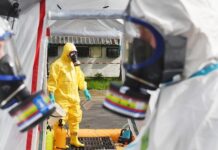 Ebola STRIKES AGAIN: Could It Trigger Chaos? Emergency responders in hazmat suits preparing for a situation