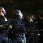 Car RAMPAGE Turns Cops into Memorial Day Victims… Police officers in riot gear standing in formation at night