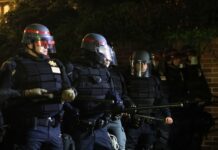 Car RAMPAGE Turns Cops into Memorial Day Victims… Police officers in riot gear standing in formation at night