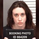 Mugshot of a woman holding a booking sign
