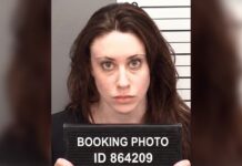 SHOCKING Spree Unleashes FEAR in Maryland Streets Mugshot of a woman holding a booking sign