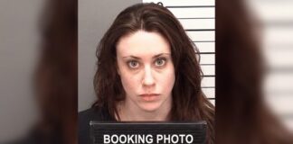 Mugshot of a woman holding a booking sign