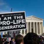 Person holds Pro-Life Generation sign at protest.