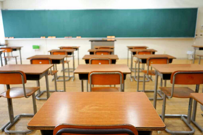 356921618-1 Empty classroom with wooden desks and chalkboard.