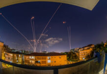 Israel Snatches Iconic Fortress — Hezbollah STUNNED… Night sky with missile defense system intercepting rockets above city.