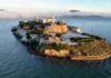 Aerial view of Alcatraz Island surrounded by water and fog