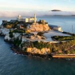 Aerial view of Alcatraz Island surrounded by water and fog