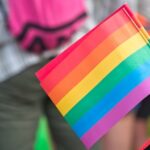 Close-up of a rainbow pride flag held by a person