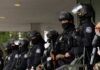 Group of police officers in riot gear standing in formation