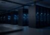 Why Trump Made America’s AI A National Security Weapon Rows of illuminated server racks in a dark data center