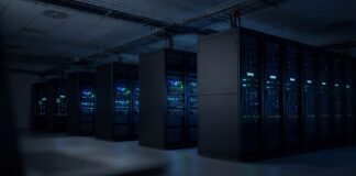 Rows of illuminated server racks in a dark data center