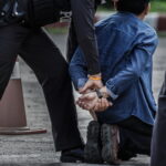 Bodycam Reveals Dying Teen Cuffed Police officers arresting a suspect in handcuffs