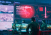 Military personnel monitor a command center screen showing missile launch alerts