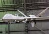 Homeland Lockdown: FCC Targets Drone Arteries military drone with missiles suspended in a hangar