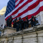 Boston Orders U.S. Flag Down — Who Approved? Police in riot gear near U.S. Capitol building.