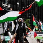 Protesters wave Palestinian flags at a city demonstration