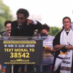 Socialism Alarm Hits Virginia Speaker at outdoor rally gestures from a podium