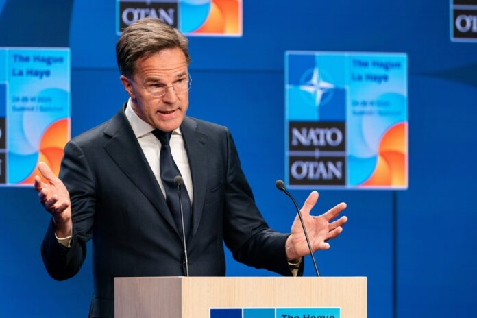 Den,Haag,,Netherlands,-,June,23,2025:,Nato,Secretary,General Man in suit speaking at podium with NATO backdrop