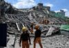 Tsunami Alert After Monster Quake Rescue workers survey collapsed building debris
