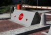 Britain’s New Normal: Hostile Vehicle Mitigation Rising road blocker with stop sign at a security checkpoint