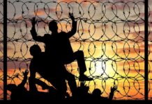 28 Illegals Pile Out of a Single Van After Arizona Crash Silhouettes of people climbing a barbed wire fence at sunset