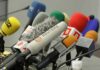 Iran Declares THESE News Outlets ‘Military Targets’ A collection of various microphones arranged for a press conference
