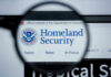 Magnifying glass showing Homeland Security website.