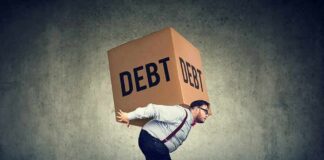 Man carrying a large box labeled debt on his back