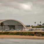 airport hangar with helicopters near a shoreline