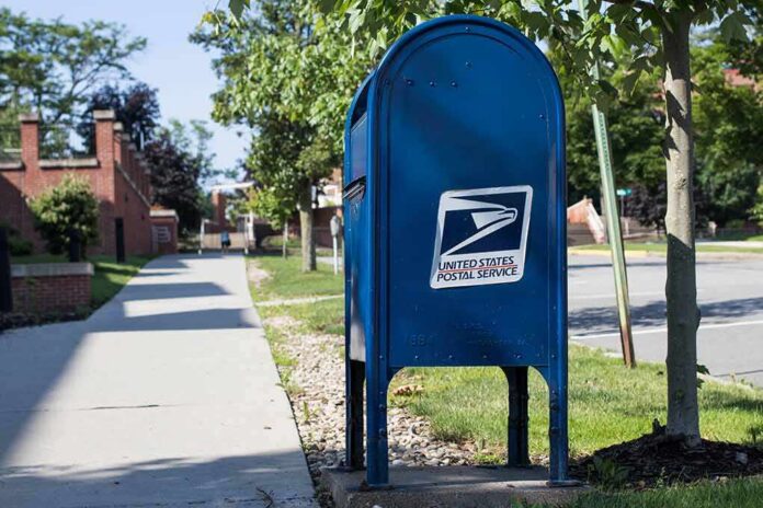 Blue USPS mailbox on a suburban sidewalk