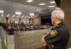Trusted Officer, Unthinkable Allegations security officer overseeing a crowded school cafeteria